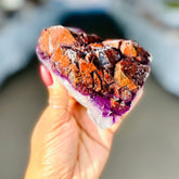 sunlit Alien Amethyst crystal chunk held up by woman at Energy Muse